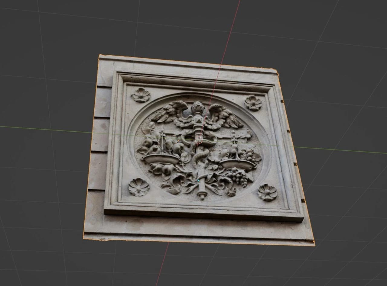 The textured stone panel tilted in the Blender viewport, with its carved details and projecting frame visible.