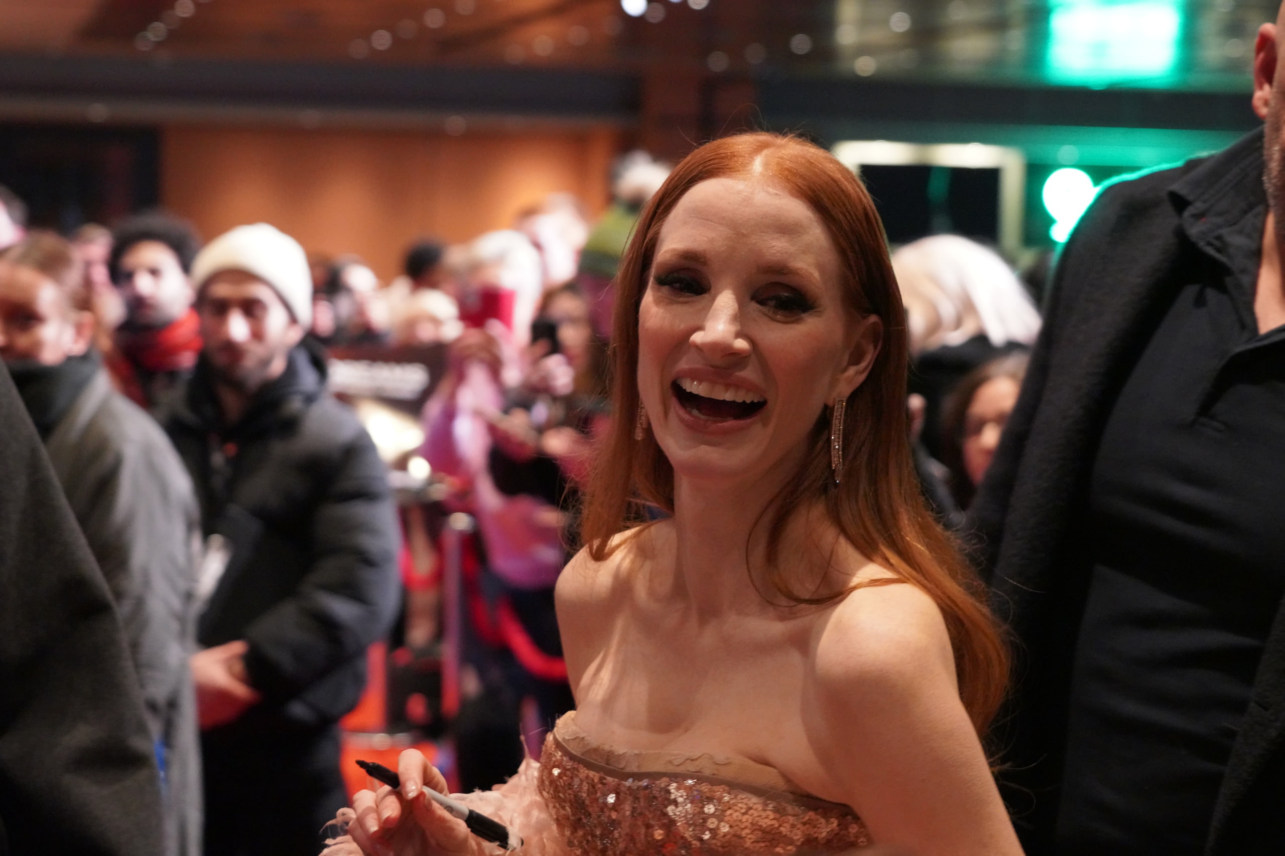 Jessica Chastain laughing with fans in the crowd at the Dreams premiere.