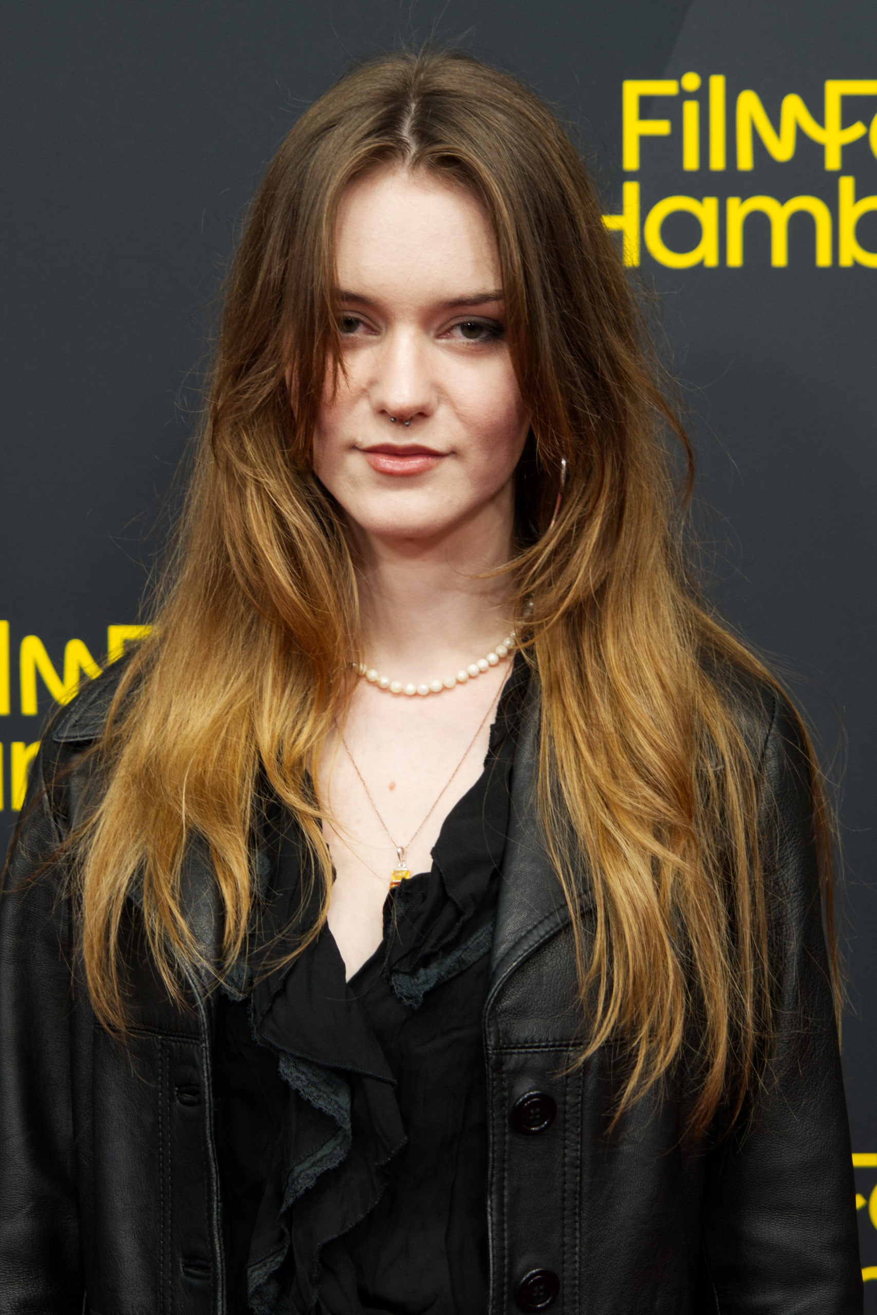 Close portrait of Rebecca Schulz in a black leather jacket at Filmfest Hamburg.