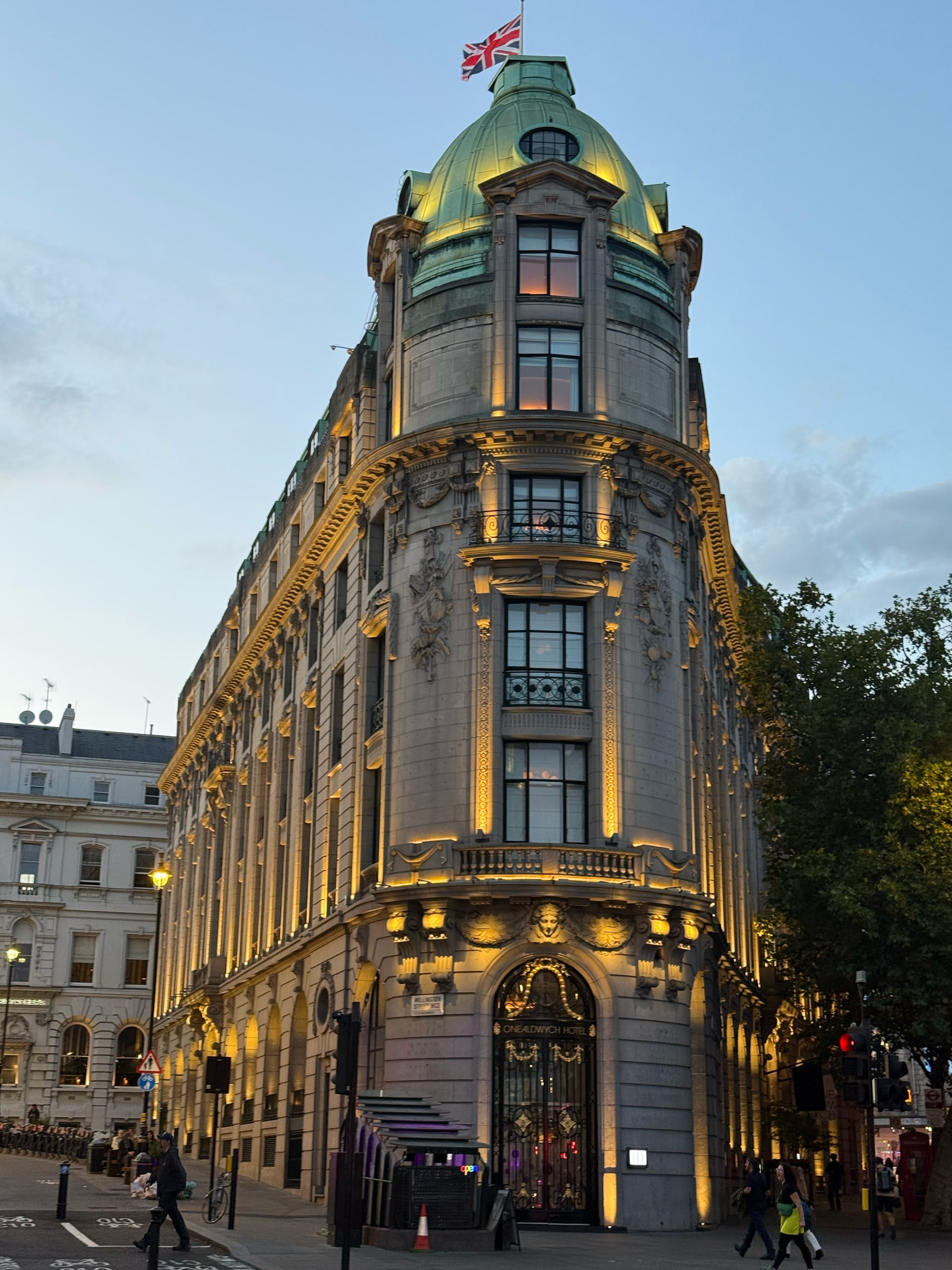 An ornate corner tower catching the last warm light at blue hour.