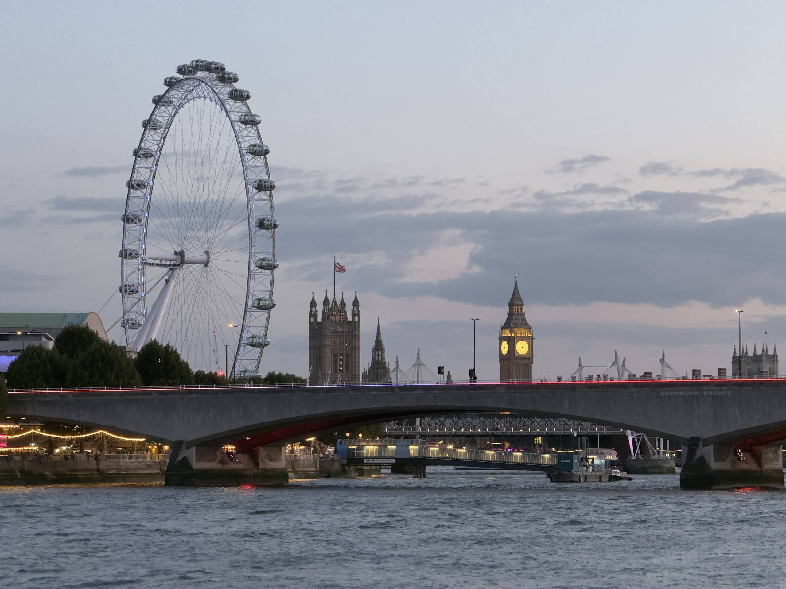 The London Eye and the Palace of Westminster seen from Waterloo Bridge at dusk.
