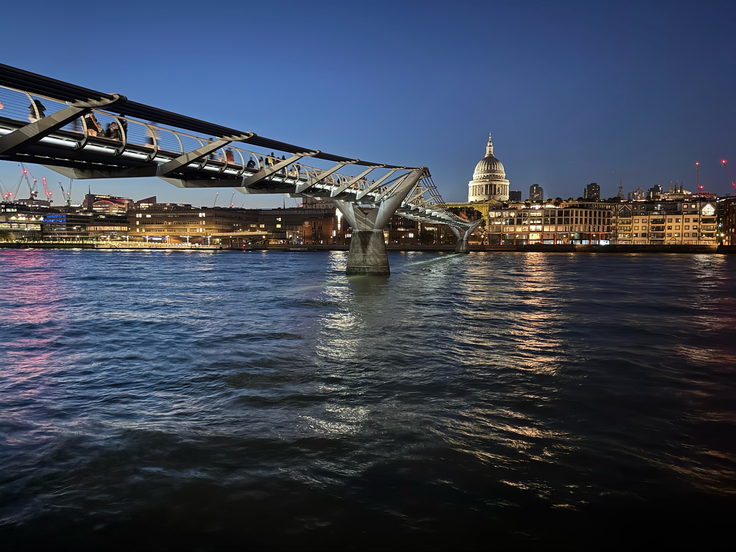 The Millennium Bridge leading to St Paul's Cathedral at blue hour.