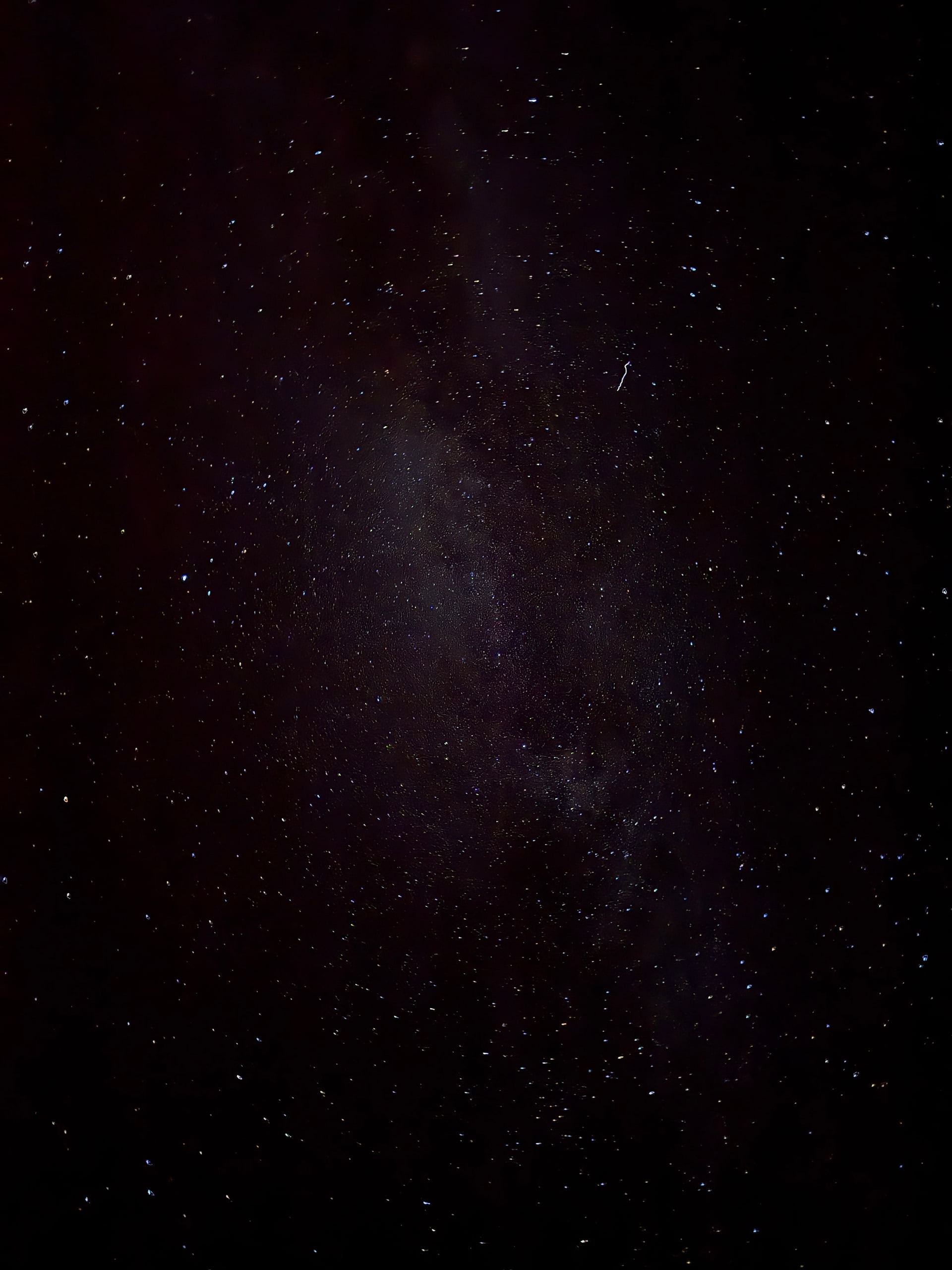 The Milky Way running vertically through a dark night sky.