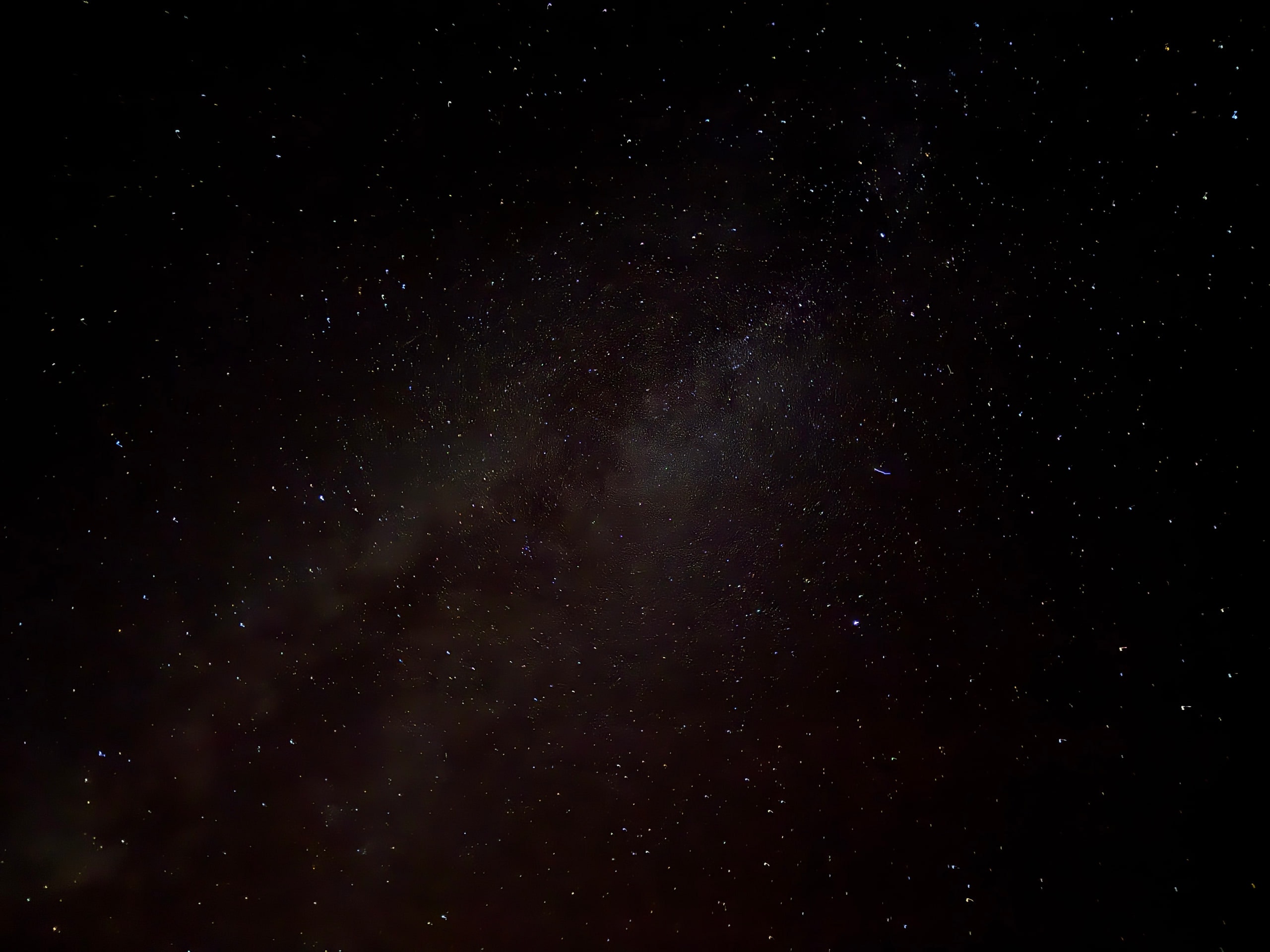 The Milky Way visible above a low dark horizon.
