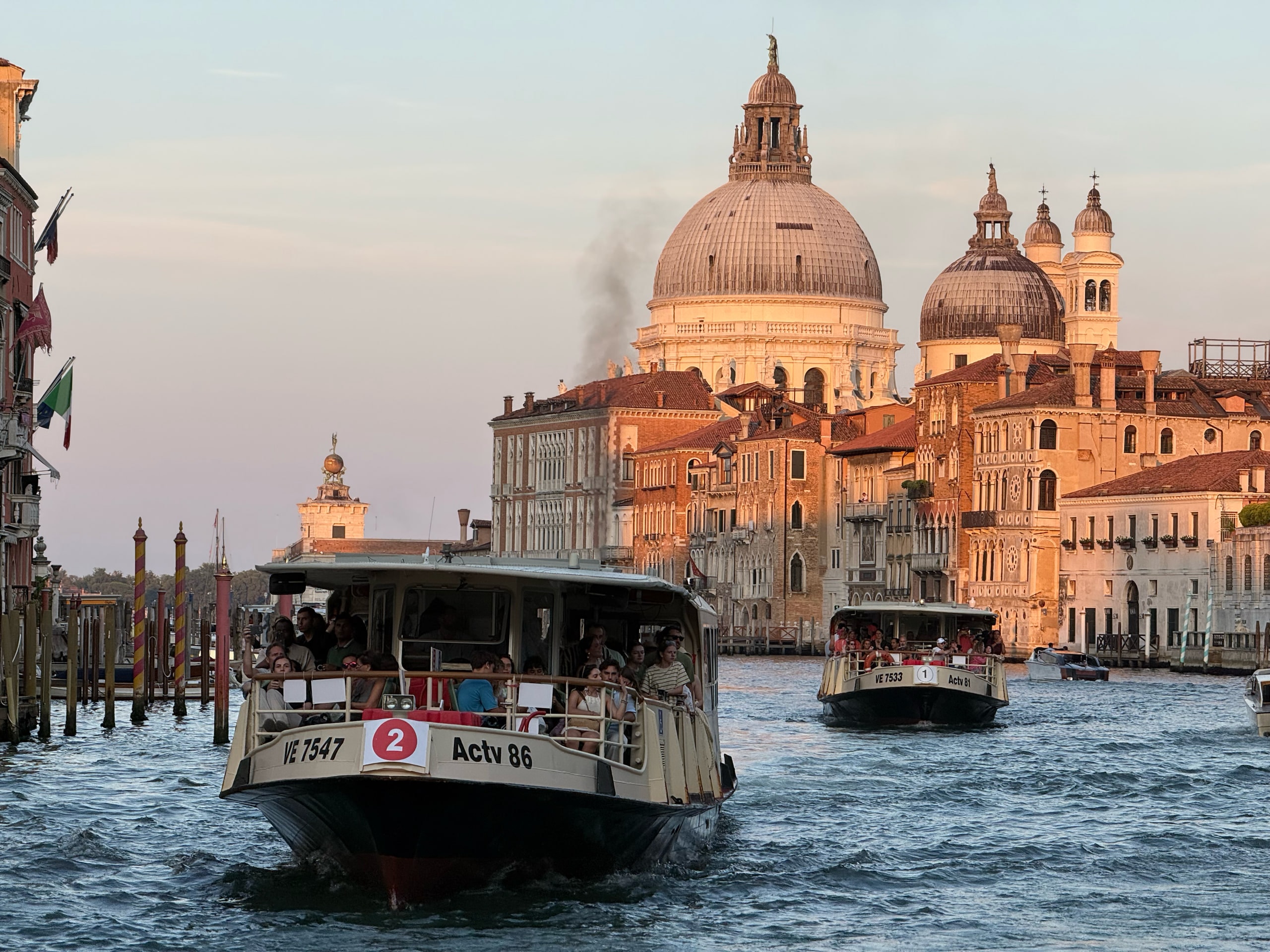 Vaporetti crossing the Grand Canal with the dome of Santa Maria della Salute behind.