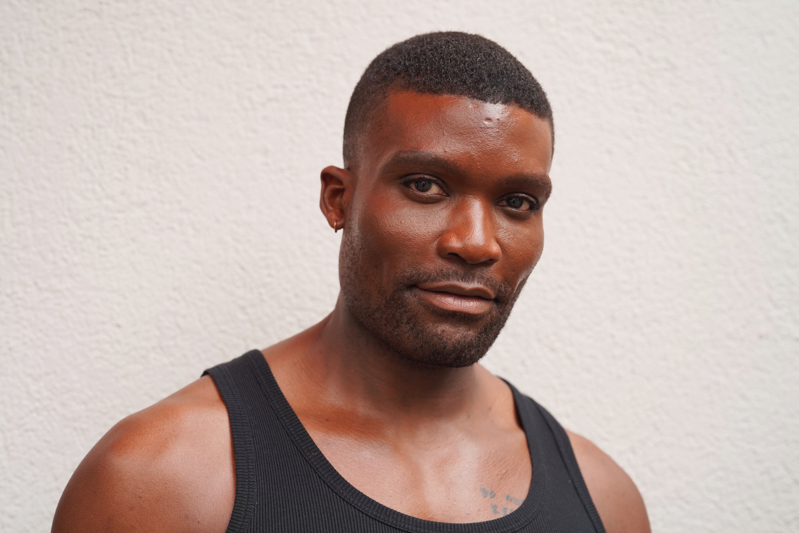 Close portrait of Michael Solomon in a black vest, meeting the camera's gaze.