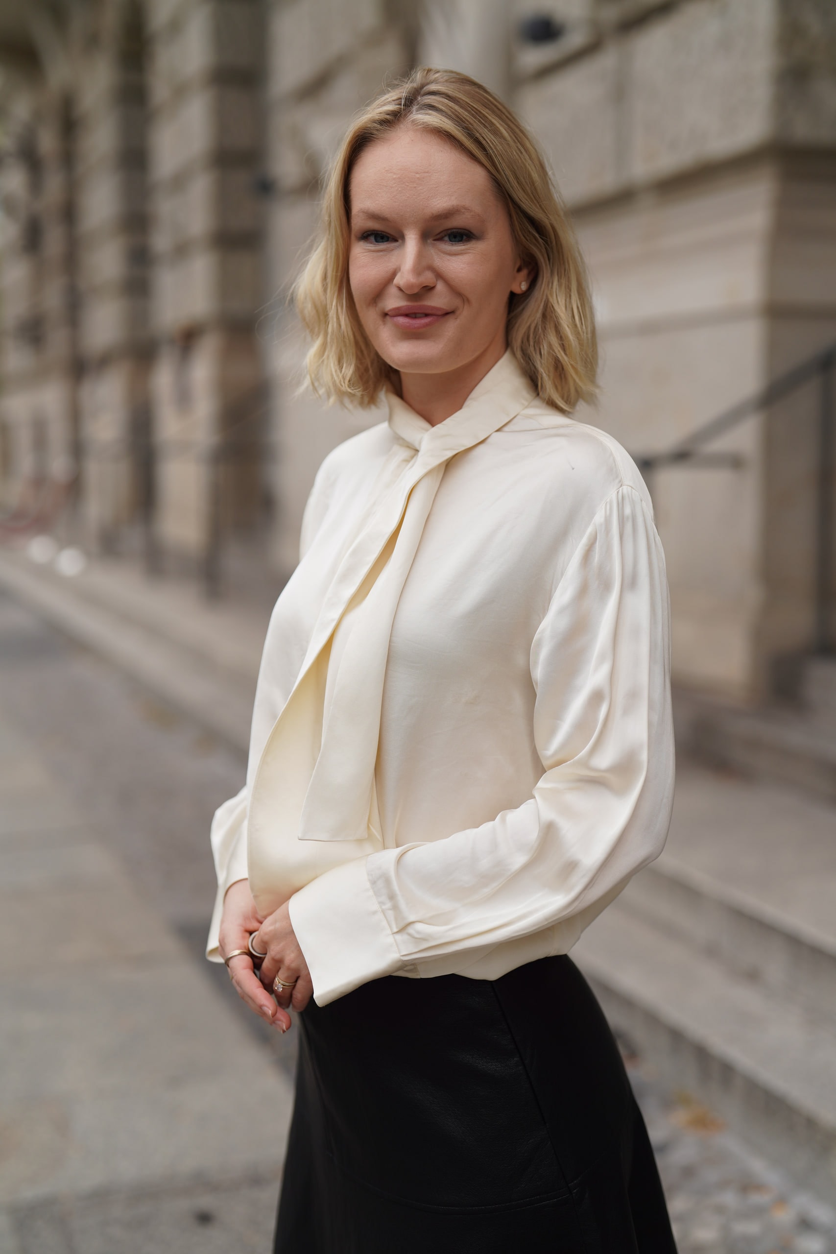 Sophia Repp turned toward the camera on a Berlin pavement beside an ornate stone facade.