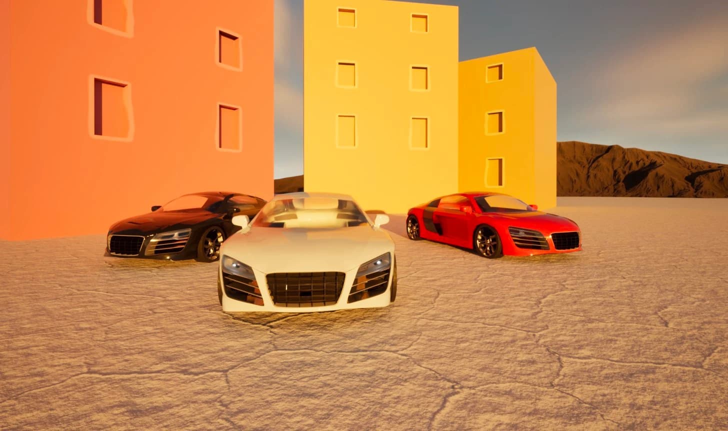 Three Audi R8 models in white, black and red, arranged in front of orange and yellow buildings in warm light.