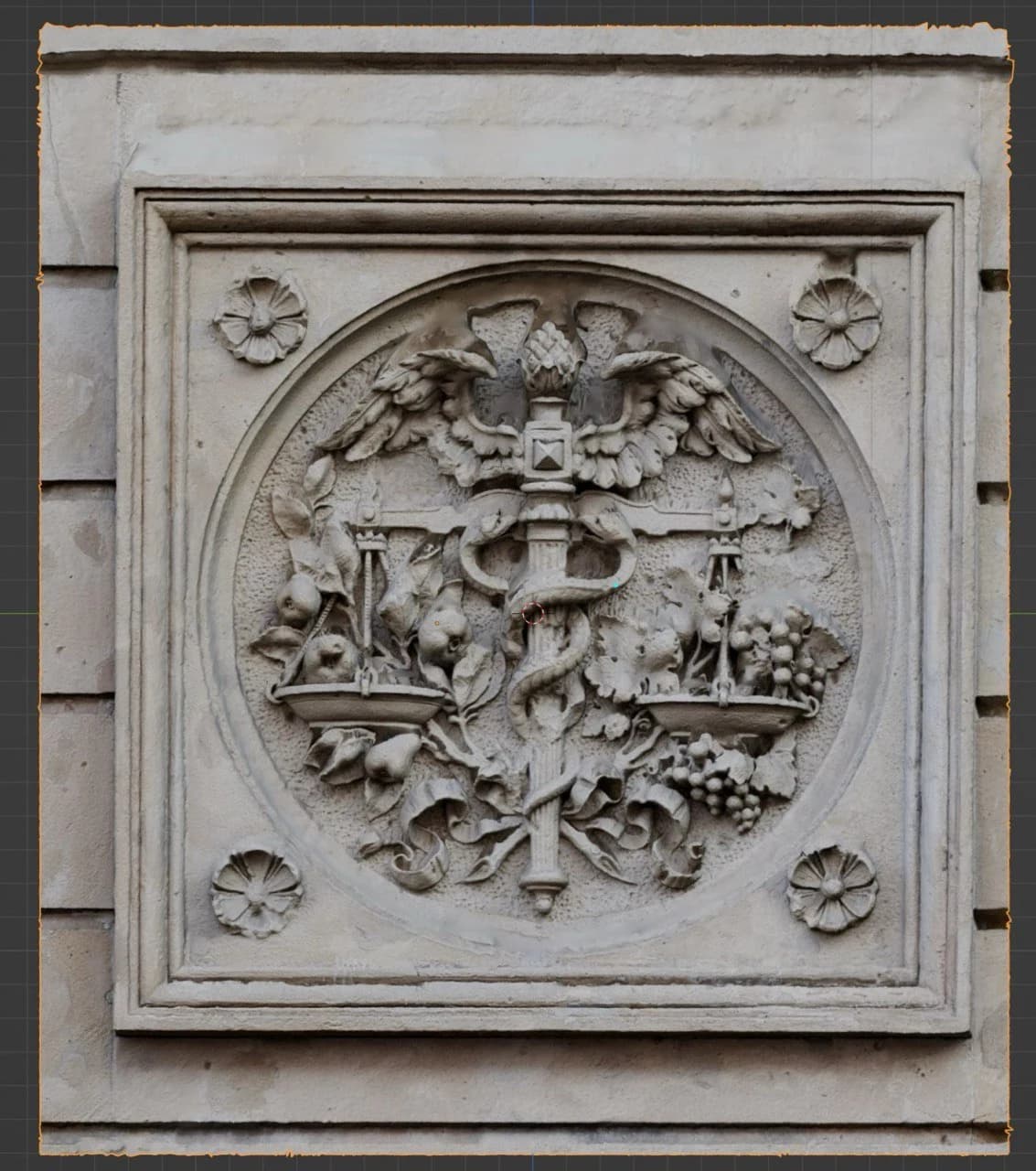 An ornate stone relief with figures and foliage inside a circular medallion, surrounded by a rectangular moulded frame.